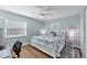 Stylish bedroom featuring a large bed with a coastal-themed comforter, and hardwood floors at 10500 Sherman St, Englewood, FL 34224