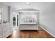 Bright main bedroom with hardwood floors, tray ceiling, and a sliding door to a private balcony at 10500 Sherman St, Englewood, FL 34224