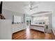 Bright main bedroom with hardwood floors, tray ceiling, and a sliding door to a private balcony at 10500 Sherman St, Englewood, FL 34224