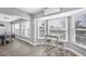 Eat-in breakfast nook bathed in sunlight, highlighting views from several large windows and comfortable seating at 10500 Sherman St, Englewood, FL 34224