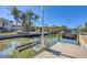 Private dock with boat lift on a tranquil canal, ideal for boating enthusiasts at 10500 Sherman St, Englewood, FL 34224