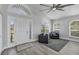 Bright and airy entryway features a modern grey color scheme, beautiful hardwood floors, and stylish furniture at 10500 Sherman St, Englewood, FL 34224