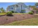 Charming two-story home with a landscaped yard and staircase leading to a covered entryway, perfect for coastal living at 10500 Sherman St, Englewood, FL 34224