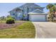 Beautiful two-story home with an attached two-car garage, landscaped yard, and inviting staircase to the front door at 10500 Sherman St, Englewood, FL 34224