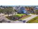 Two-story home featuring lush landscaping, palm trees, solar panels, and a driveway leading to an attached two-car garage at 10500 Sherman St, Englewood, FL 34224