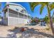 Exterior featuring backyard pool, tiki hut, lush landscaping, and canal at 10500 Sherman St, Englewood, FL 34224
