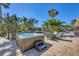 Outdoor hot tub on a brick patio, surrounded by lush tropical landscaping and a seating area at 10500 Sherman St, Englewood, FL 34224