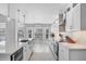 Bright, modern kitchen with stainless steel appliances, a large island, and breakfast nook at 10500 Sherman St, Englewood, FL 34224