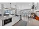 Bright, open kitchen featuring white cabinetry, stainless steel appliances, and a breakfast bar with natural light at 10500 Sherman St, Englewood, FL 34224