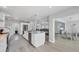 Open concept kitchen with a white island, stainless appliances and an open view to the living room at 10500 Sherman St, Englewood, FL 34224