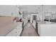 Well-lit white kitchen with stainless steel appliances, subway tile backsplash, and ample counter space at 10500 Sherman St, Englewood, FL 34224