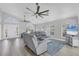 Open living room with high ceilings, lots of natural light, and modern gray furniture at 10500 Sherman St, Englewood, FL 34224