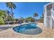 Beautiful waterfront pool with in-water seating, lush landscaping, and canal view at 10500 Sherman St, Englewood, FL 34224