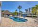 Inviting pool area with lush landscaping, tiki hut, and access to waterfront at 10500 Sherman St, Englewood, FL 34224
