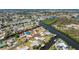 An aerial view of a charming neighborhood with waterfront homes on the canal at 1167 Delmar St, Englewood, FL 34224