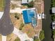 Aerial view of waterfront property with a screened in pool, boat lift, and dock at 1167 Delmar St, Englewood, FL 34224