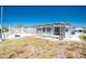 A scenic backyard view showcasing the pool, dock, and outdoor entertainment area at 1167 Delmar St, Englewood, FL 34224