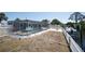 Captivating view of a backyard with a pool, and a canal with a boat lift, perfect for outdoor recreation at 1167 Delmar St, Englewood, FL 34224