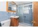 Bathroom featuring blue tile walls, a vanity with wood cabinets, and a glass-enclosed shower at 1167 Delmar St, Englewood, FL 34224