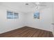 Bright bedroom with hardwood floors, two windows, and fresh white paint, ready for personal touches at 1167 Delmar St, Englewood, FL 34224