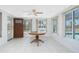 Light-filled Florida room with a round table, tile floors, and views of the pool at 1167 Delmar St, Englewood, FL 34224