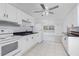 Well-lit kitchen includes white appliances, countertops, and cabinets for an airy feel at 1167 Delmar St, Englewood, FL 34224