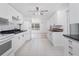 The kitchen features white appliances, dark counters, and light tile flooring at 1167 Delmar St, Englewood, FL 34224