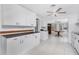 Bright kitchen features white cabinets, black countertops, and access to Florida room at 1167 Delmar St, Englewood, FL 34224