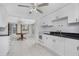 Cozy kitchen features white cabinets, black countertops, and an adjoining dining area at 1167 Delmar St, Englewood, FL 34224