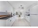 Bright kitchen with white cabinets, black countertops, and tile flooring at 1167 Delmar St, Englewood, FL 34224