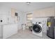 Practical laundry area with washer, sink, cabinets, and room for additional appliances at 1167 Delmar St, Englewood, FL 34224