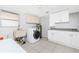 Well-equipped laundry room with washer, dryer, sink, cabinets, and ample counter space at 1167 Delmar St, Englewood, FL 34224