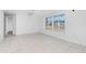 Bright living room with tile floors, neutral walls, and a large window for ample natural light at 1167 Delmar St, Englewood, FL 34224