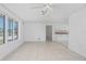 Neutral living space features tile flooring and an open concept to the kitchen at 1167 Delmar St, Englewood, FL 34224
