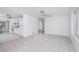 Spacious, neutral living area features tile flooring and an open concept to the kitchen at 1167 Delmar St, Englewood, FL 34224
