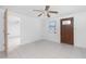 Neutral living area featuring white tile flooring, a ceiling fan, and access to two additional rooms at 1167 Delmar St, Englewood, FL 34224