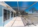 Spacious brick patio outside the home with a screened enclosure, ideal for entertaining and relaxation at 1167 Delmar St, Englewood, FL 34224