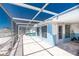 View of blue home with an enclosed patio and pool, great for outdoor relaxation at 1167 Delmar St, Englewood, FL 34224