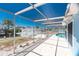 The brick patio leads out to a canal-front backyard, with a screened enclosure to create an outdoor space at 1167 Delmar St, Englewood, FL 34224