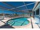 Sparkling in-ground pool in screened enclosure, offering a private oasis for leisure and recreation at 1167 Delmar St, Englewood, FL 34224