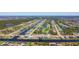 Expansive aerial view of a residential community with waterfront homes along canals and a golf course at 1167 Rotonda Cir, Rotonda West, FL 33947