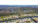 This aerial view captures a waterfront community surrounded by lush greenery and waterways at 1167 Rotonda Cir, Rotonda West, FL 33947