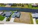 Aerial view of modern waterfront home with pool and spacious lot backing up to a canal at 1167 Rotonda Cir, Rotonda West, FL 33947