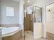 Well appointed bathroom with glass shower, garden tub, and stylish chevron wallpaper at 1167 Rotonda Cir, Rotonda West, FL 33947
