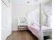 Bedroom featuring a four poster canopy bed, makeup vanity, and wood floors at 1167 Rotonda Cir, Rotonda West, FL 33947