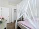 Bright bedroom featuring hardwood floors, canopy bed, and a closet for ample storage at 1167 Rotonda Cir, Rotonda West, FL 33947