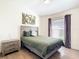Cozy bedroom featuring a decorative print over the bed and hardwood floors at 1167 Rotonda Cir, Rotonda West, FL 33947