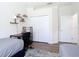 Bright bedroom featuring hardwood floors, a desk, and a closet for ample storage at 1167 Rotonda Cir, Rotonda West, FL 33947