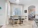 Bright dining room with a stylish chandelier, seating for six, and an archway leading to the living area at 1167 Rotonda Cir, Rotonda West, FL 33947