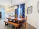 This dining room features a wooden dining table, bench, and eye-catching chandelier at 1167 Rotonda Cir, Rotonda West, FL 33947